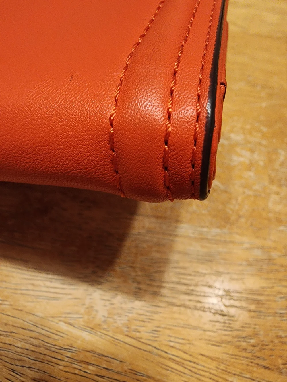 Coach Campbell Leather Buckle Medium Wallet in a vibrant orange shade with brass
